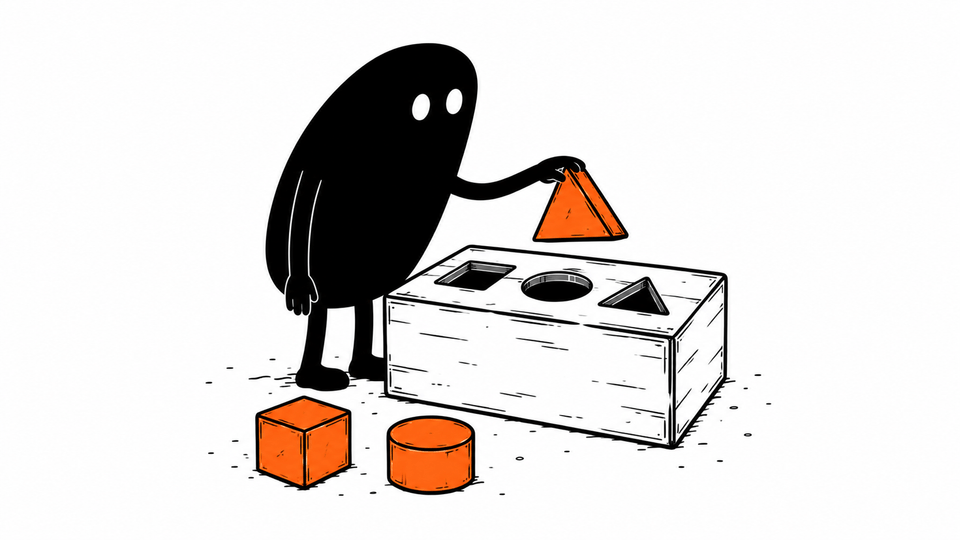 Lev fits an orange triangular block into the matching hole of a shape-sorter box.