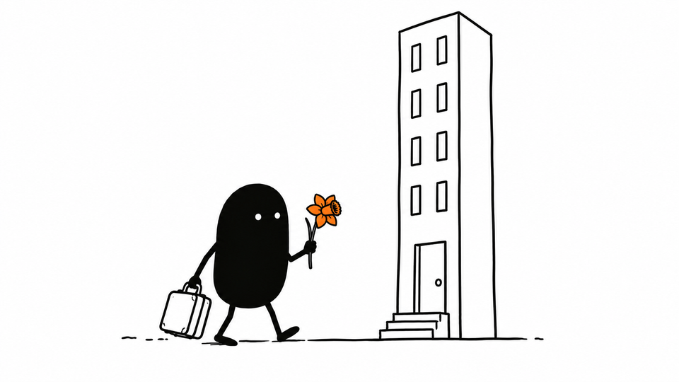 Lev walks towards a tall building carrying a small suitcase and a single orange daffodil.